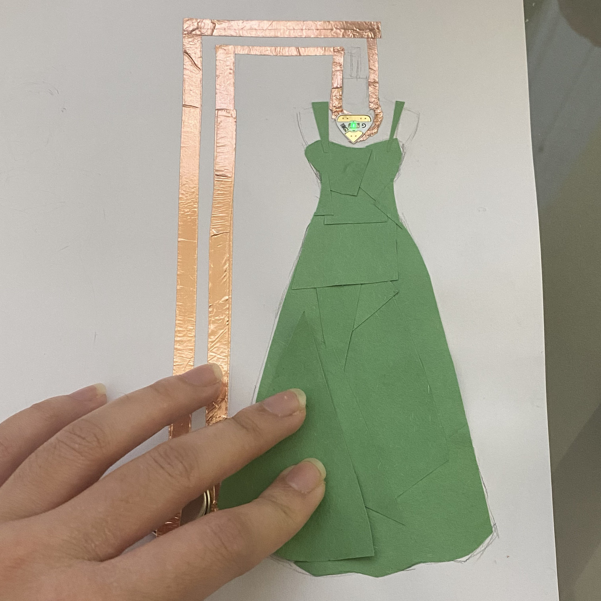 This is the previous circuit, but lit up. The necklace lights up once you finish the dress piece.