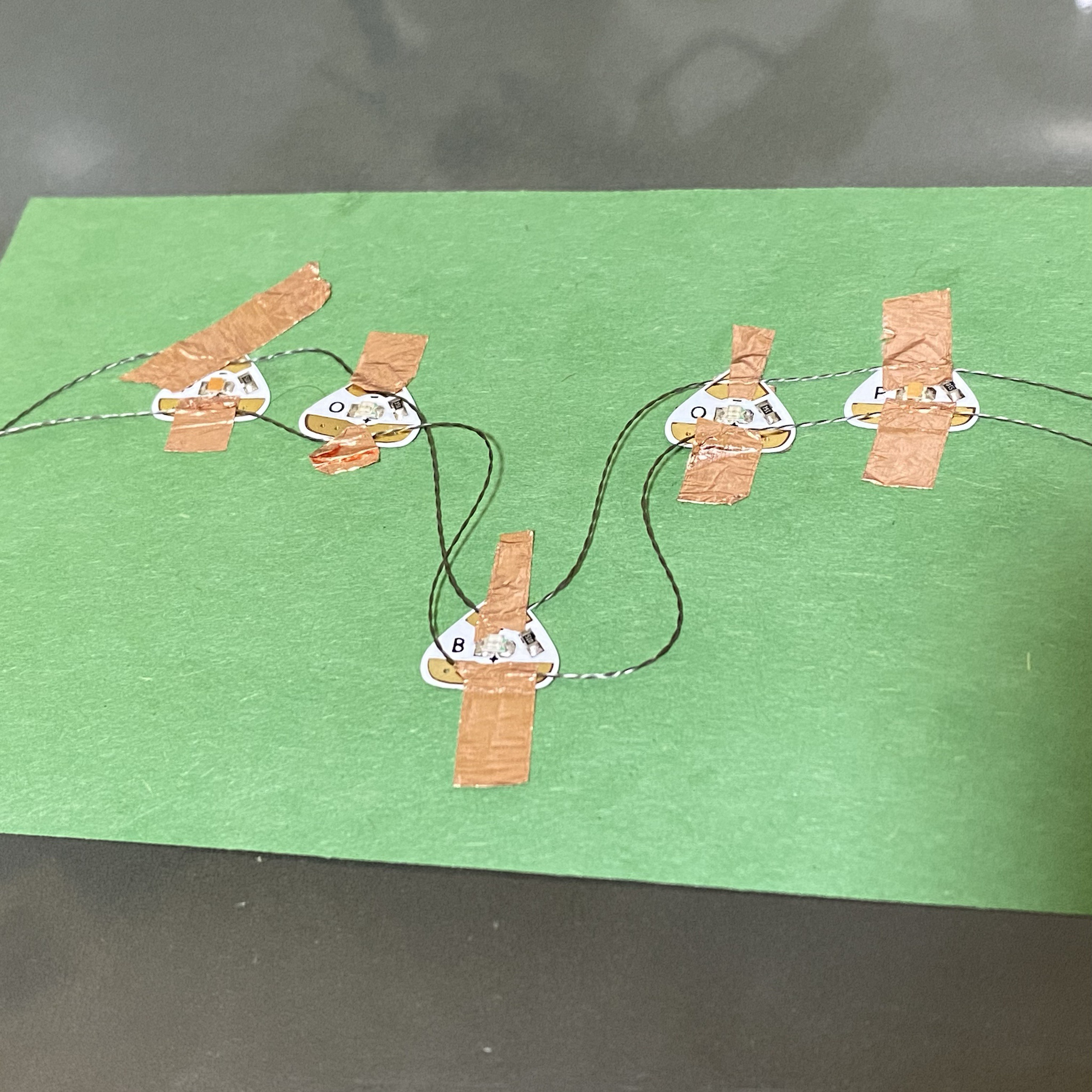 I also used the conductive wire and tape for this because I wanted to further experiment. This is an image where none of the LEDs were lighting up - it was definitely finnicky at first, but I was able to sory it out by adjusting the placement of the wire onto the LEDs.